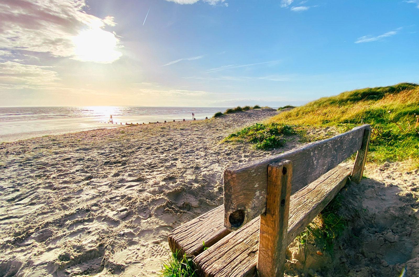 Explore the Witterings Image of a bench and the sea