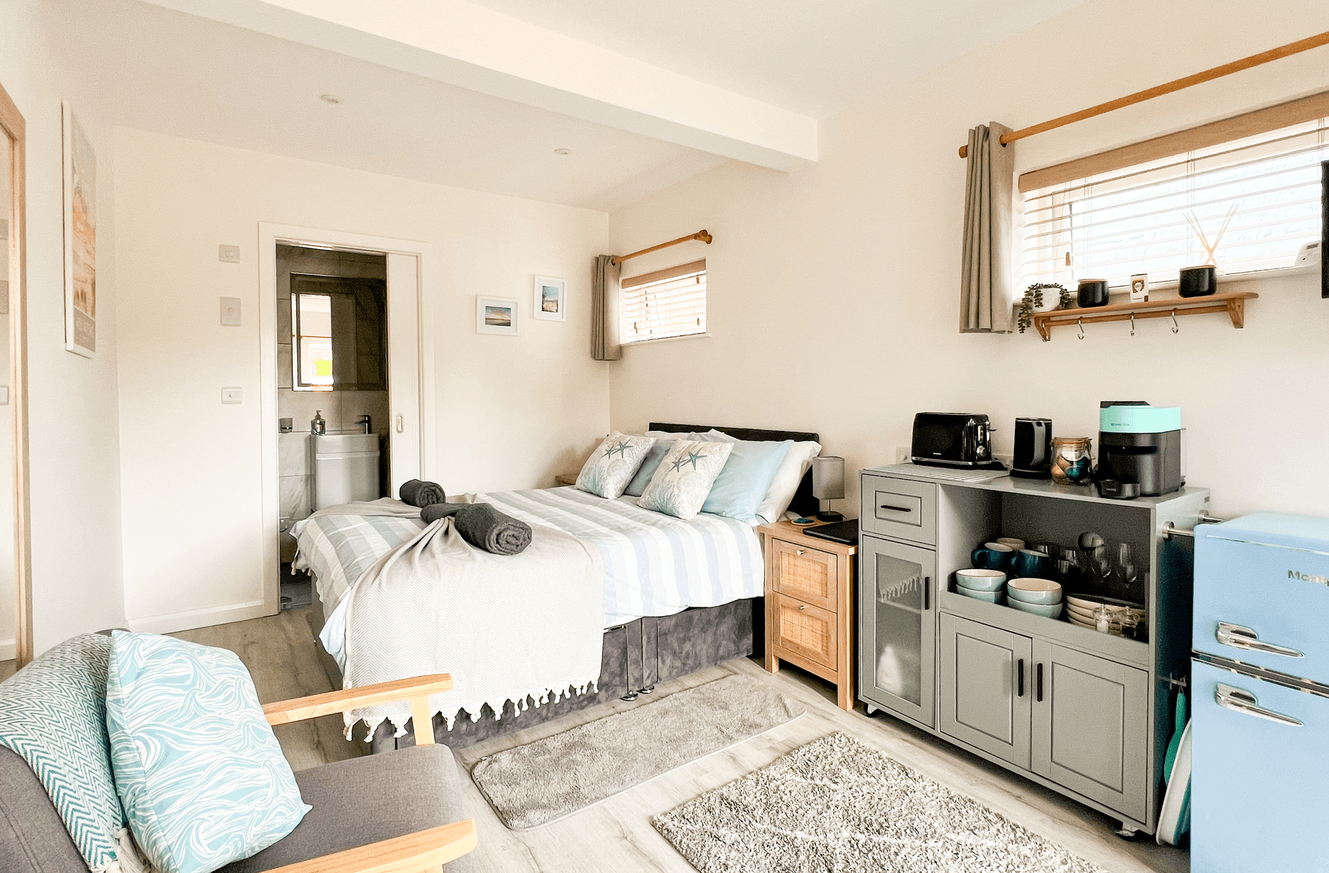 Ocean Lodge Image A cosy looking lodge room in the Witterings with a small kitchen uinit and a set of seats.