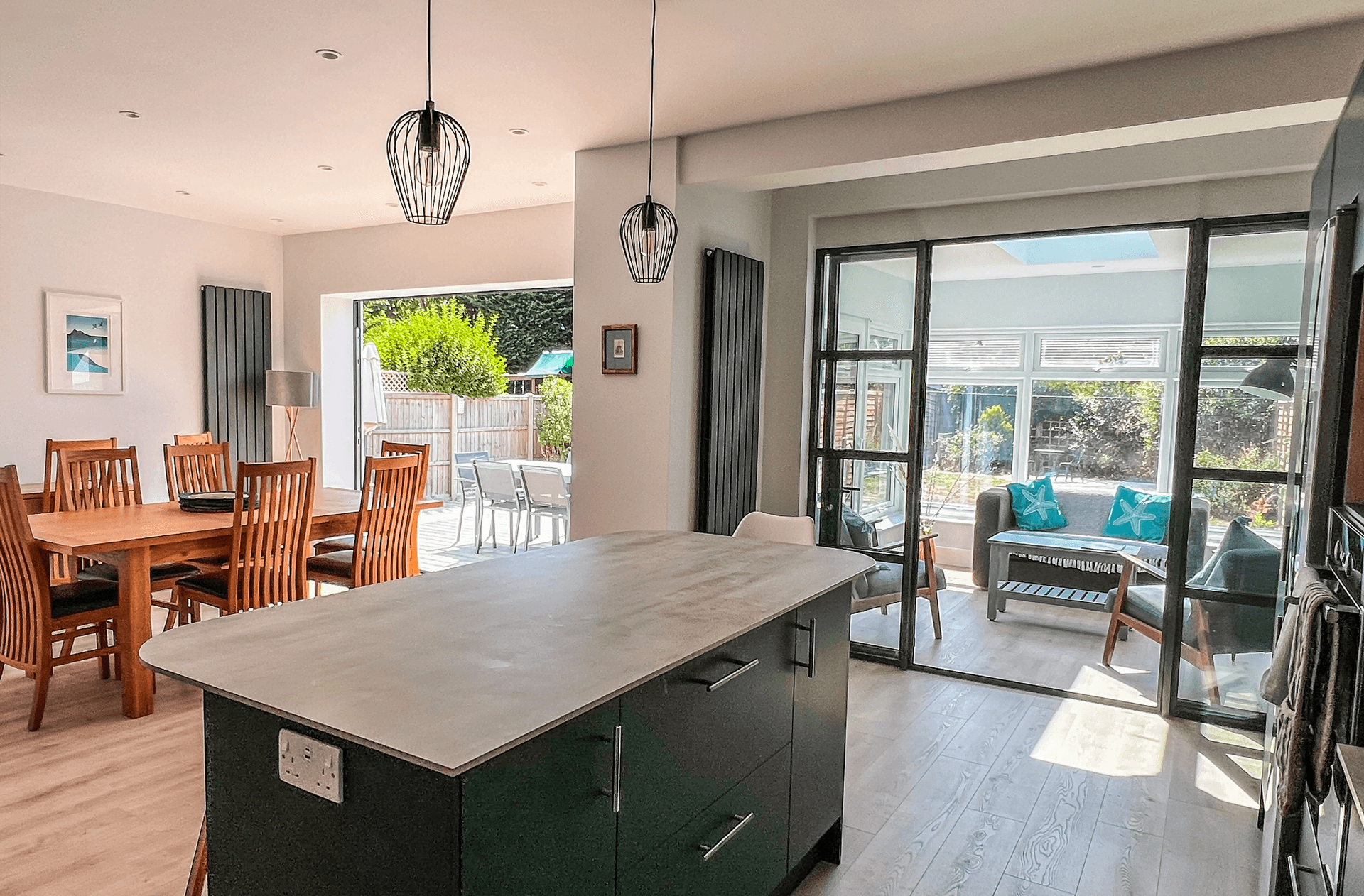Ocean Grove Image A kitchen with clean work surfaces. A window looks out onto the view outside.