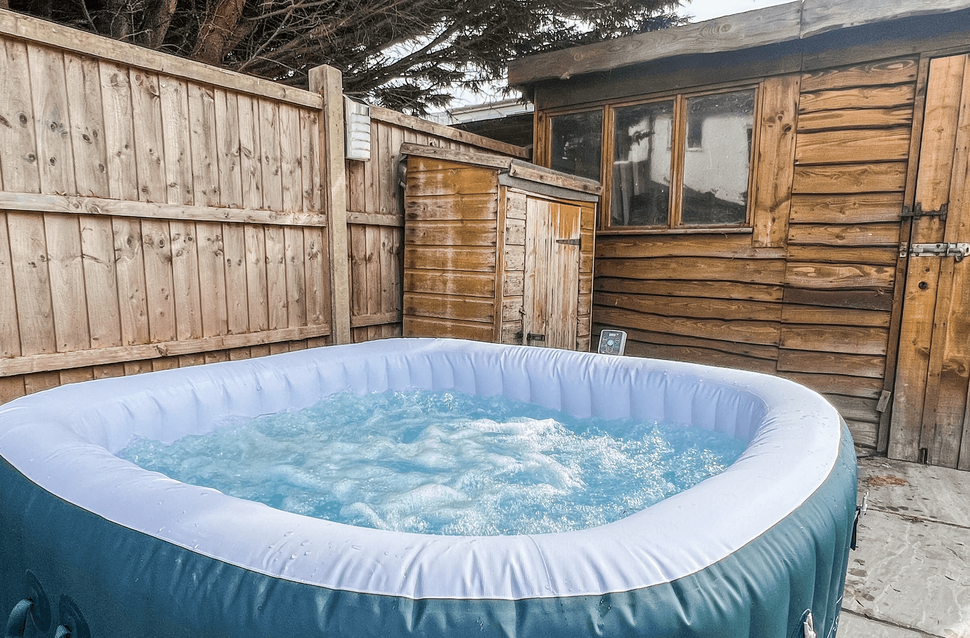 Ocean Grove Image A hot tub bubbles with a shed in the background.
